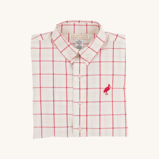 Folded white shirt with red grid pattern and small logo on a white background