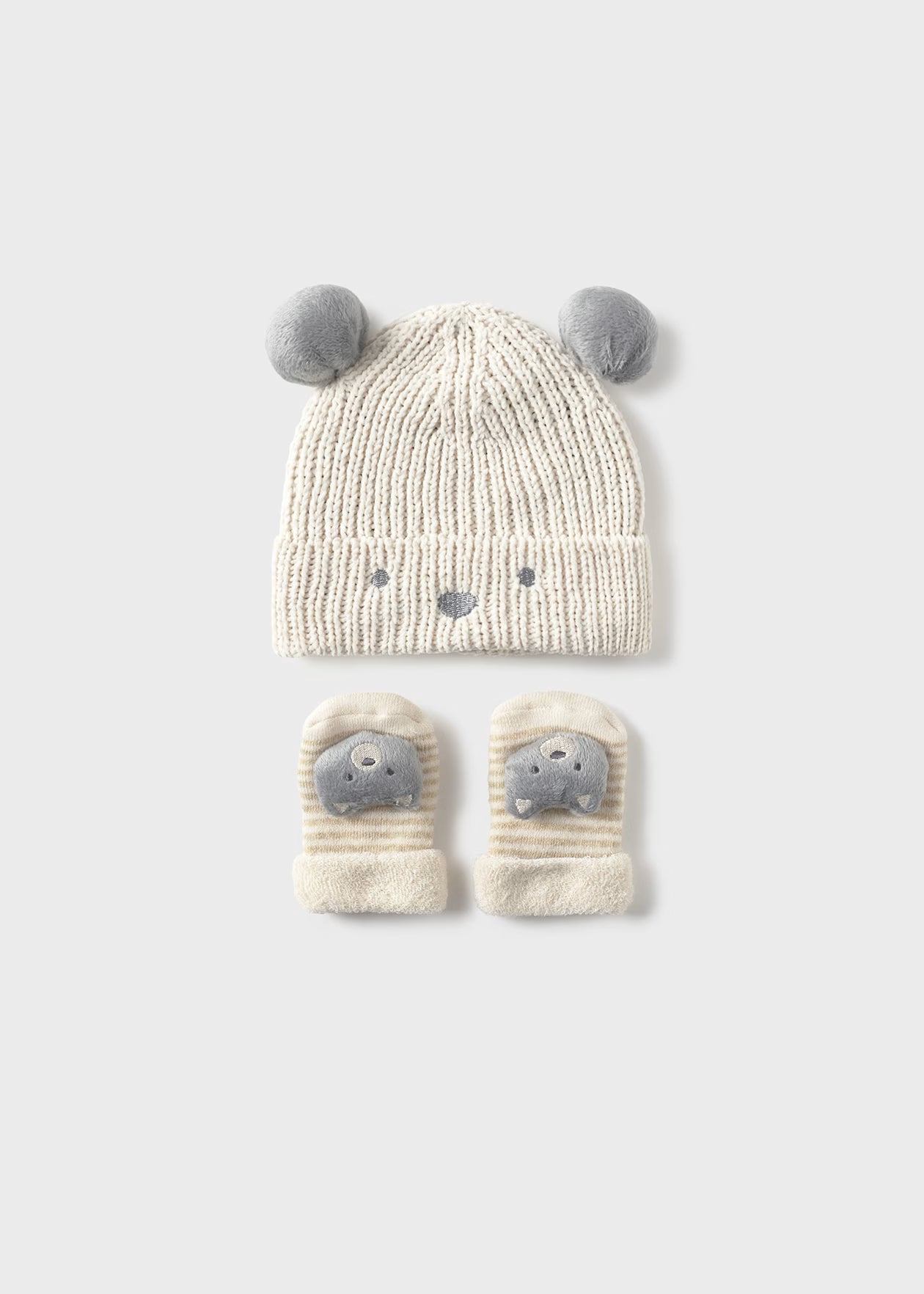 Knitted hat and mittens set with animal face design on a white background
