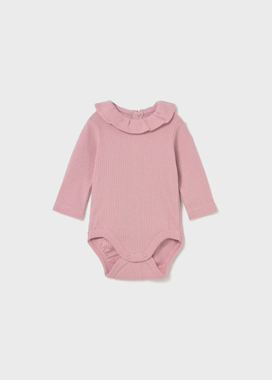 Pink ribbed baby bodysuit with a ruffled collar on a light gray background