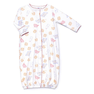 White converter gown with milk and cookies pattern, snaps down the front, and fold-over cuffs.