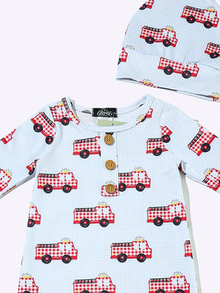 White baby gown with red gingham firetruck print, button placket, and matching knotted hat.