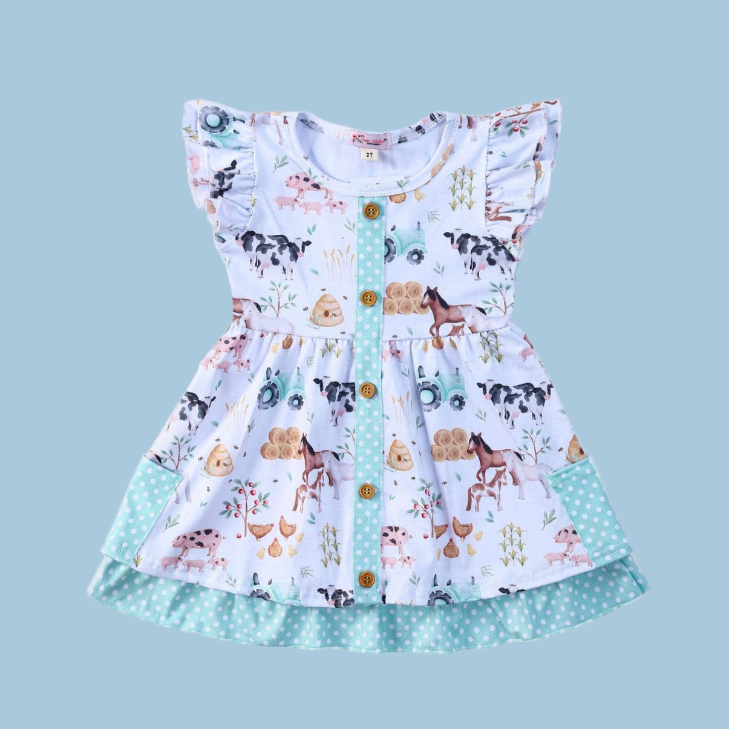 Children's dress with farm animal print on a white background