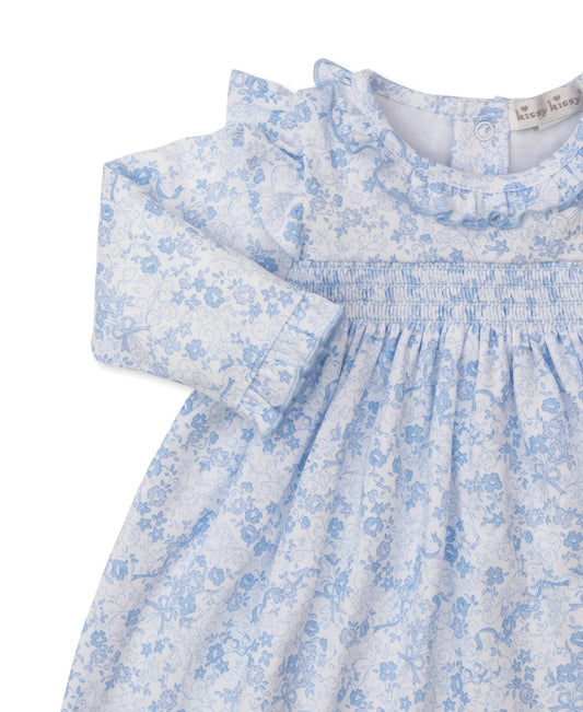 Blue floral dress with ruffled collar on a white background