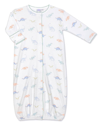 White gown with colorful dinosaur print, featuring snaps down the front and fold over cuffs.