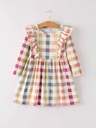 Plaid dress with ruffled sleeves on a hanger against a white background