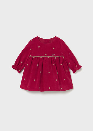 Red dress with gold polka dots on a white background