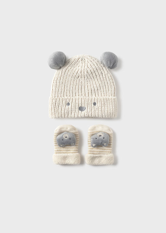 Knitted hat and mittens set with animal face design on a white background