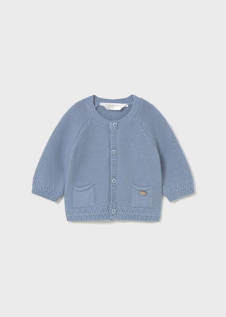 Blue knitted cardigan on a light gray background
