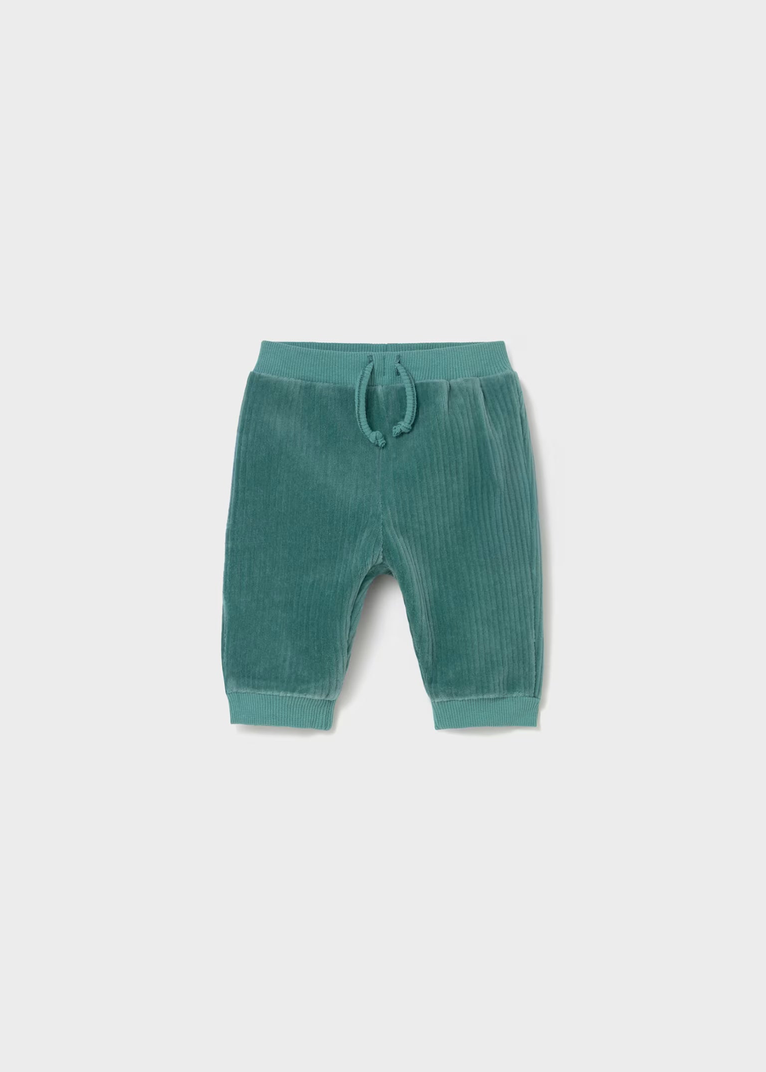 Green baby pants with a drawstring on a light gray background