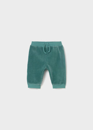 Green baby pants with a drawstring on a light gray background