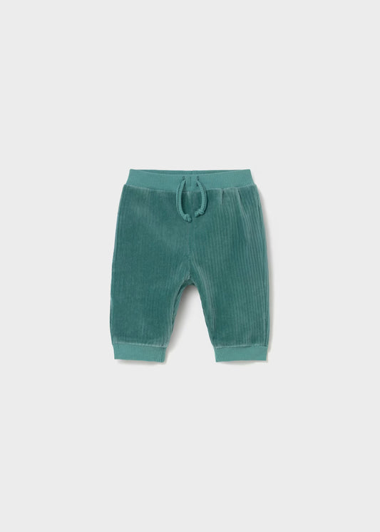 Green baby pants with a drawstring on a light gray background