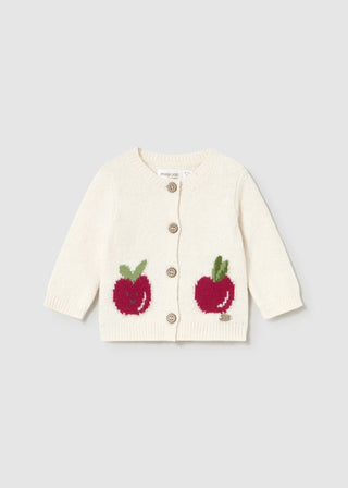 White cardigan with red apple designs on a light gray background