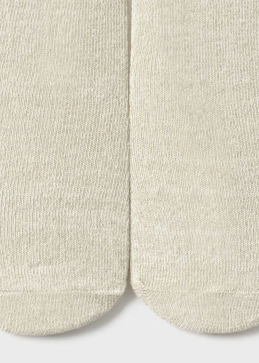 Close-up of beige socks on a light gray background