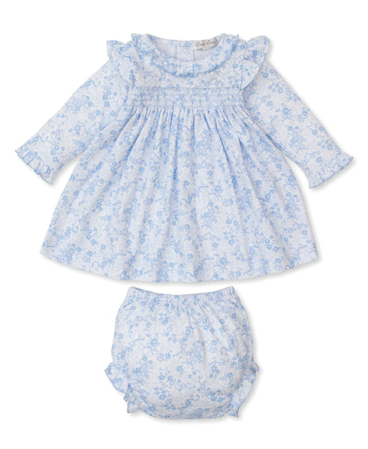 Baby dress and bloomers set with blue floral pattern on a white background
